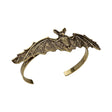 Antiqued Gold Bat Bracelet — A gold-tone metal bracelet built around a bat with its wings spread across the wrist.
