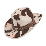 Cow Print Cowboy Hat — A cowboy hat in black and white cow-print polyester, with a shaped crown and a brim that curls up at
