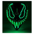 Green LED Monster Mask — A rigid full-face monster mask with a heavy brow and a wide fanged grin, lit by green LEDs that trac