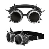Steampunk Spiked Goggles in Antique Silver — A pair of round aviator-style goggles in an antique silver finish, studded with spikes around the ri