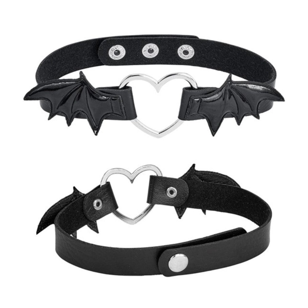 Winged Heart Choker — A black faux-leather choker band with a small heart pendant framed by a pair of bat wings.